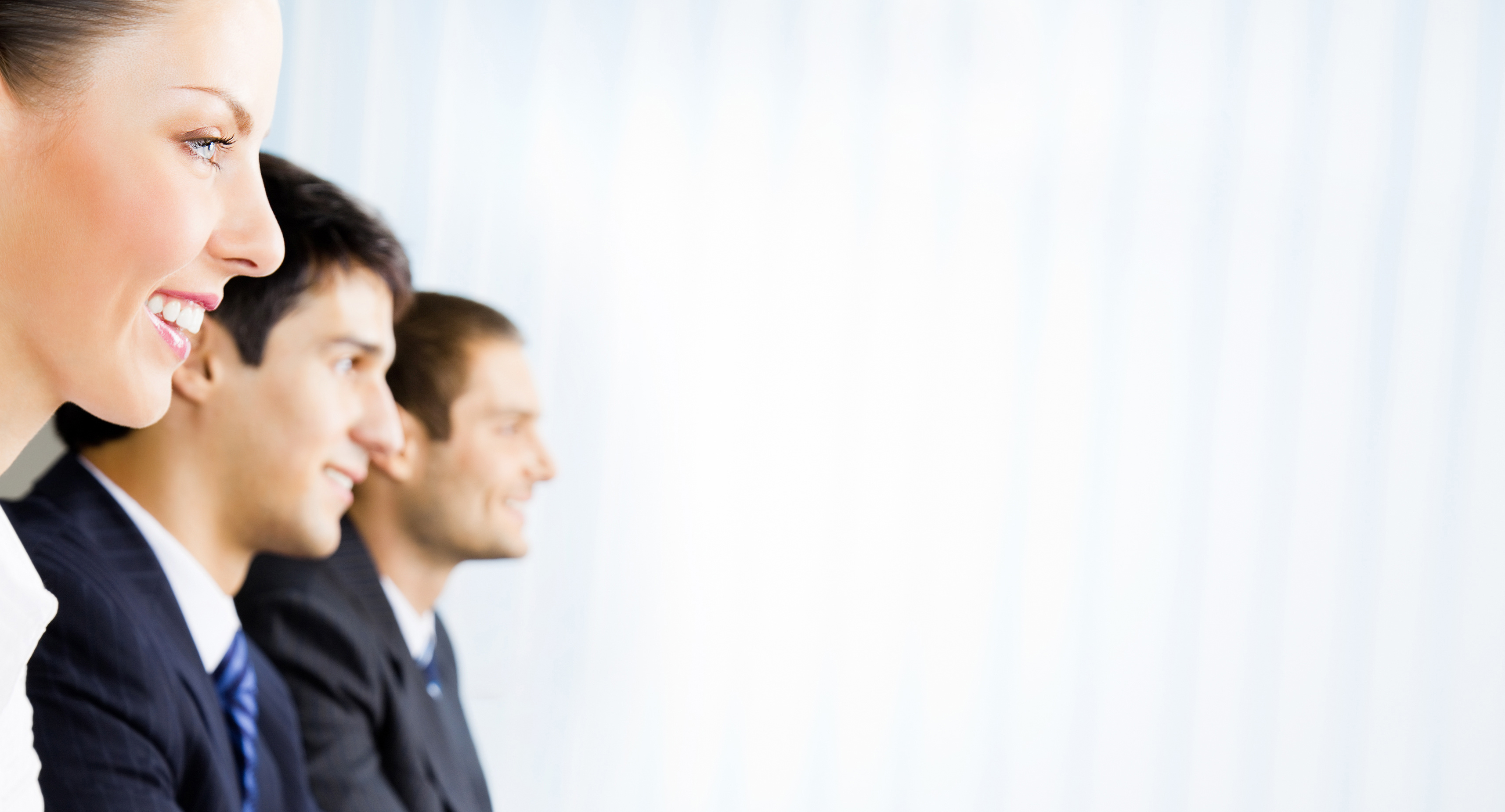 Three young happy smiling successful businesspeople at meeting, presentation or conference, with copyspace